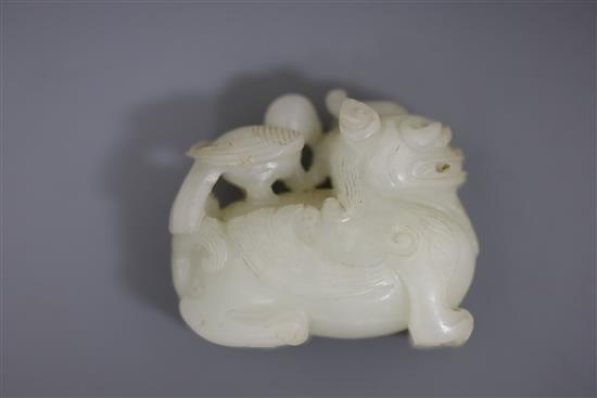 A Chinese white jade figure of bixi with a bird on its back, 17th/18th century, L. 5.4cm, wood stand